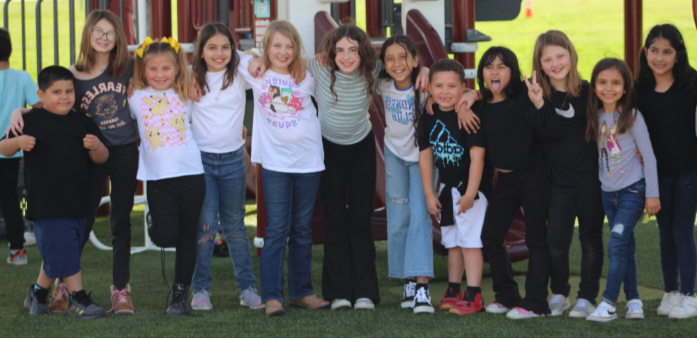 Several children standing together in front of a playground